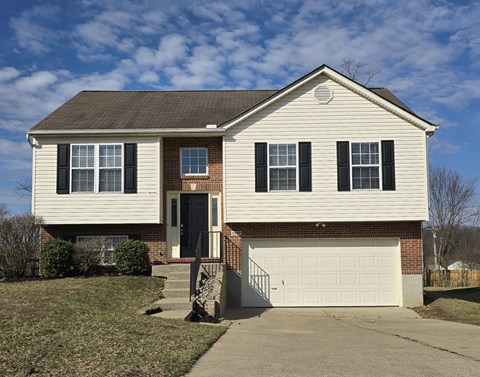 A two-story house with a white garage door.